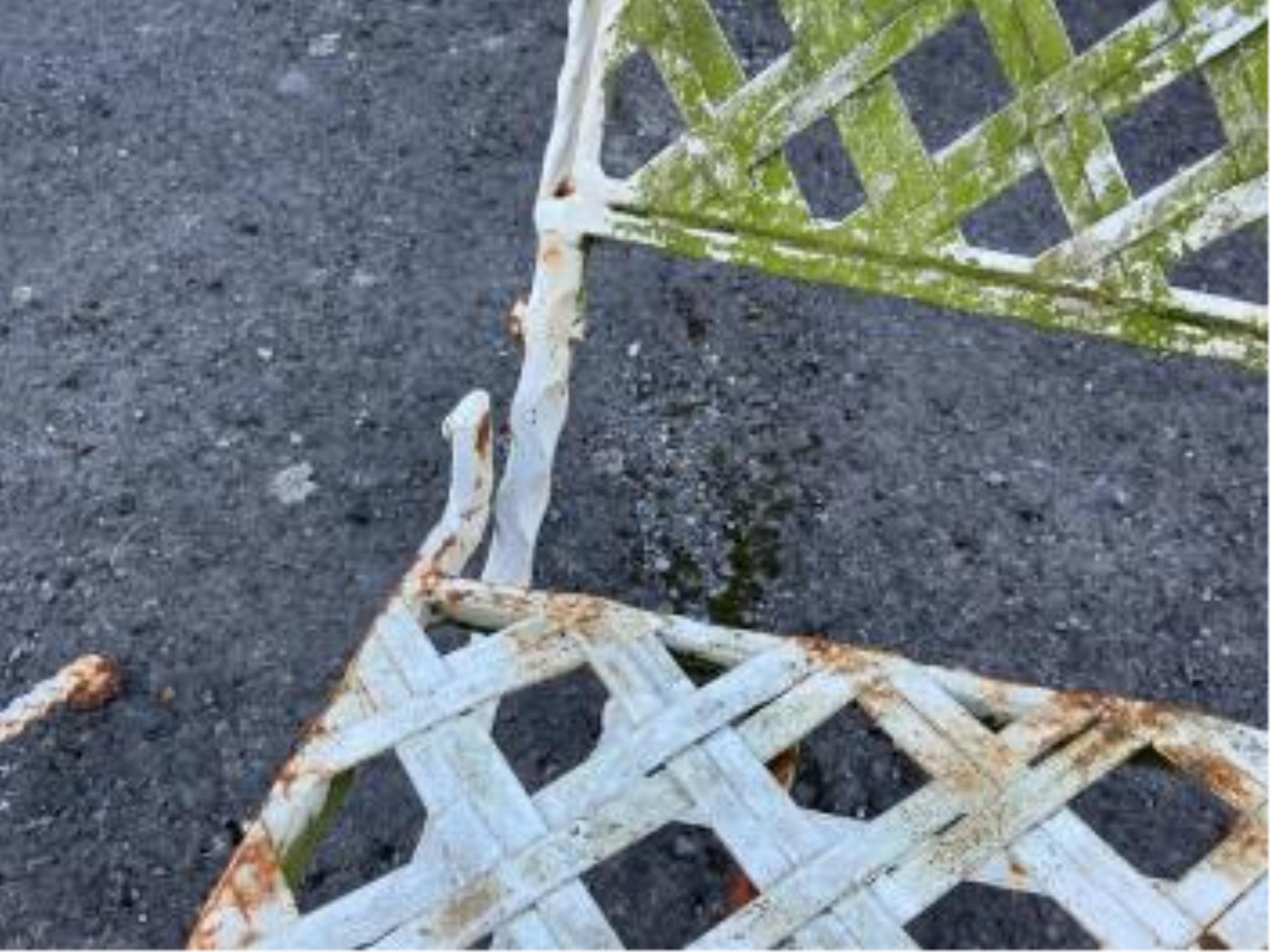 A mosaic topped demi-lune wrought iron garden table, width 96cm and a circular metal folding table with two chairs (requiring new bolts)
